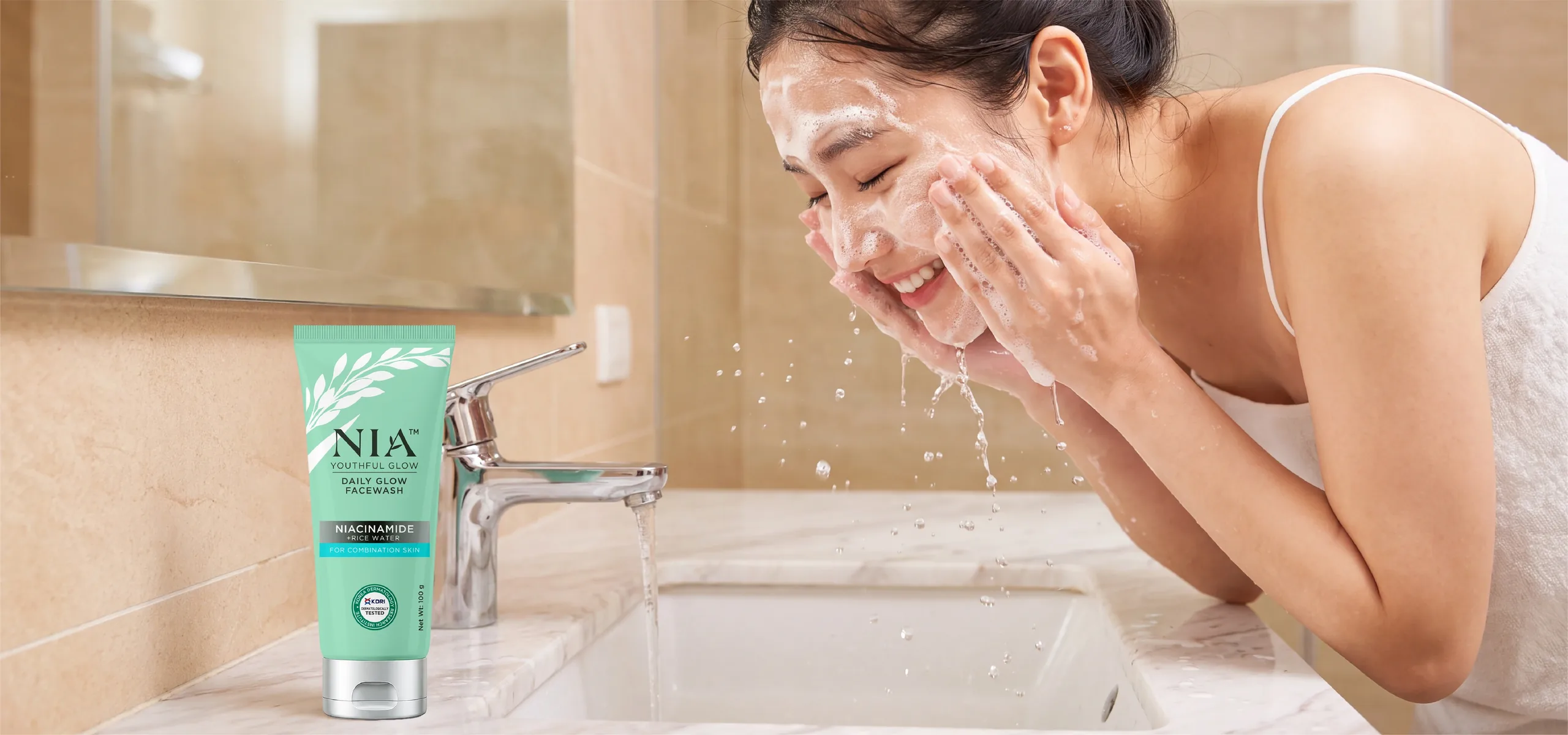NIA Daily Glow Facewash cleanse routine at bathroom sink